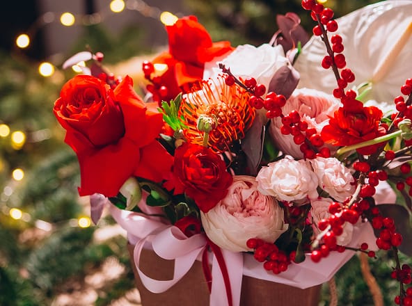 An image of a vase of seasonal winter flowers.