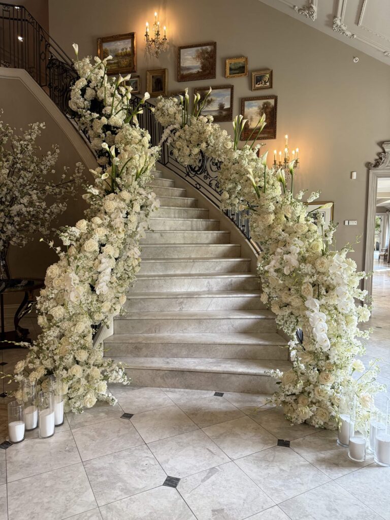 a picture of flowers on railing on either side of staircase